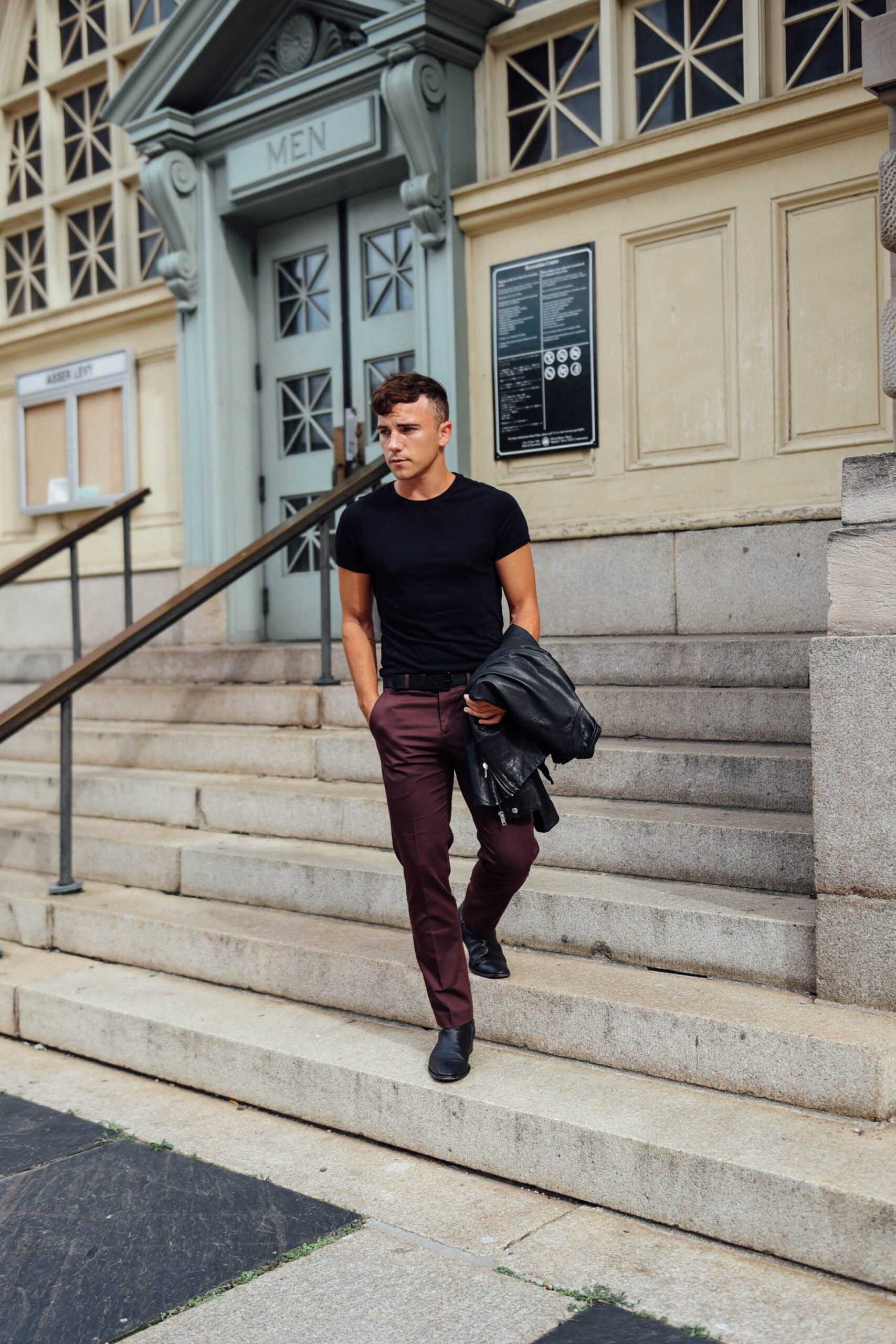 Men's Fashion Travel and Lifestyle Blogger Justin Livingston wears Express Men's Slim Suit and Leather Moto Jacket in New York City