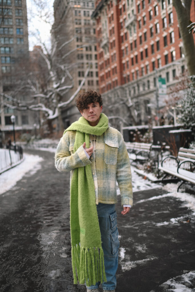 Scout Sixteen - Justin Livingston. Men's Winter Style. Cargo Denmi with Pastel Spring Coat and Lime Green Scarf. NYC.