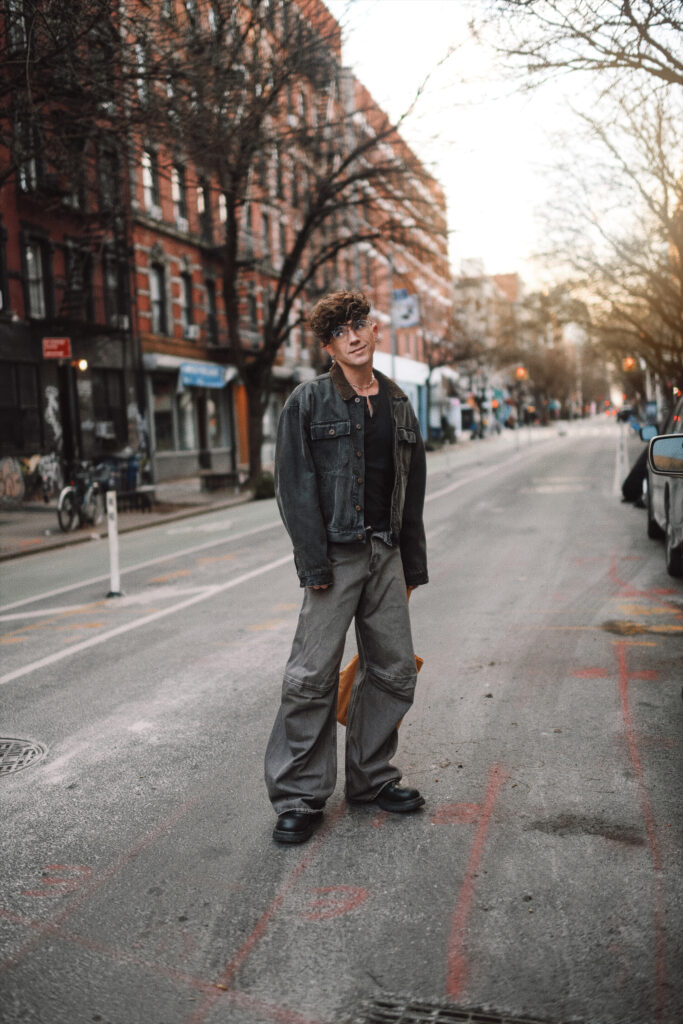 Scout Sixteen - Justin Livingston. Men's Fashion. Yeezy Denim Jacket, Ultra Wide Leg Jeans, Black Henley Tee, Bottega Veneta Black Boots