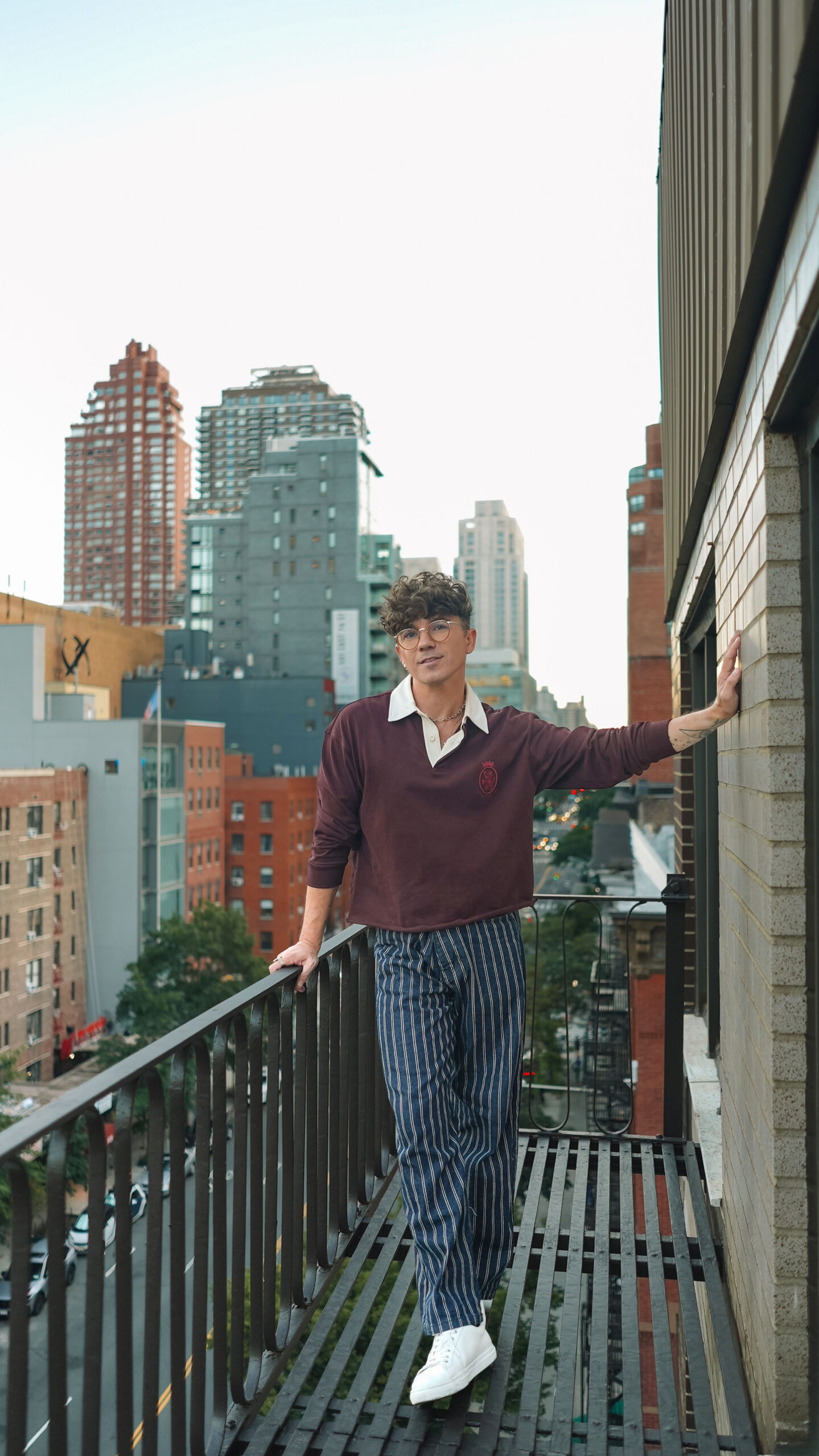 Scout Sixteen / Justin Livingston (justinliv) NYC Men's Fashion Inspiration - Maroon Men's Rugby Shirt Tommy Hilfiger, Men's Striped Blue Jeans Pants, Men's White Leather Sneakers Thursday Boots, New York City Skyline