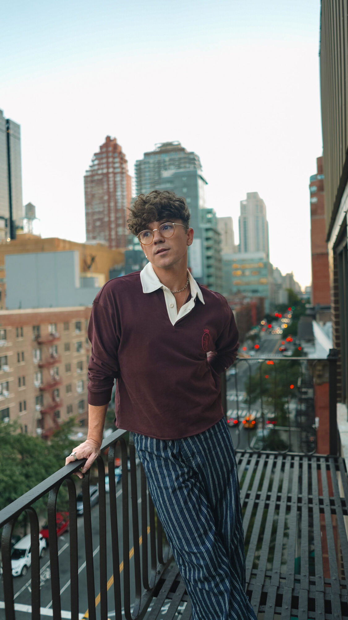 Scout Sixteen / Justin Livingston (justinliv) NYC Men's Fashion Inspiration - Maroon Men's Rugby Shirt Tommy Hilfiger, Men's Striped Blue Jeans Pants, Men's White Leather Sneakers Thursday Boots, New York City Skyline