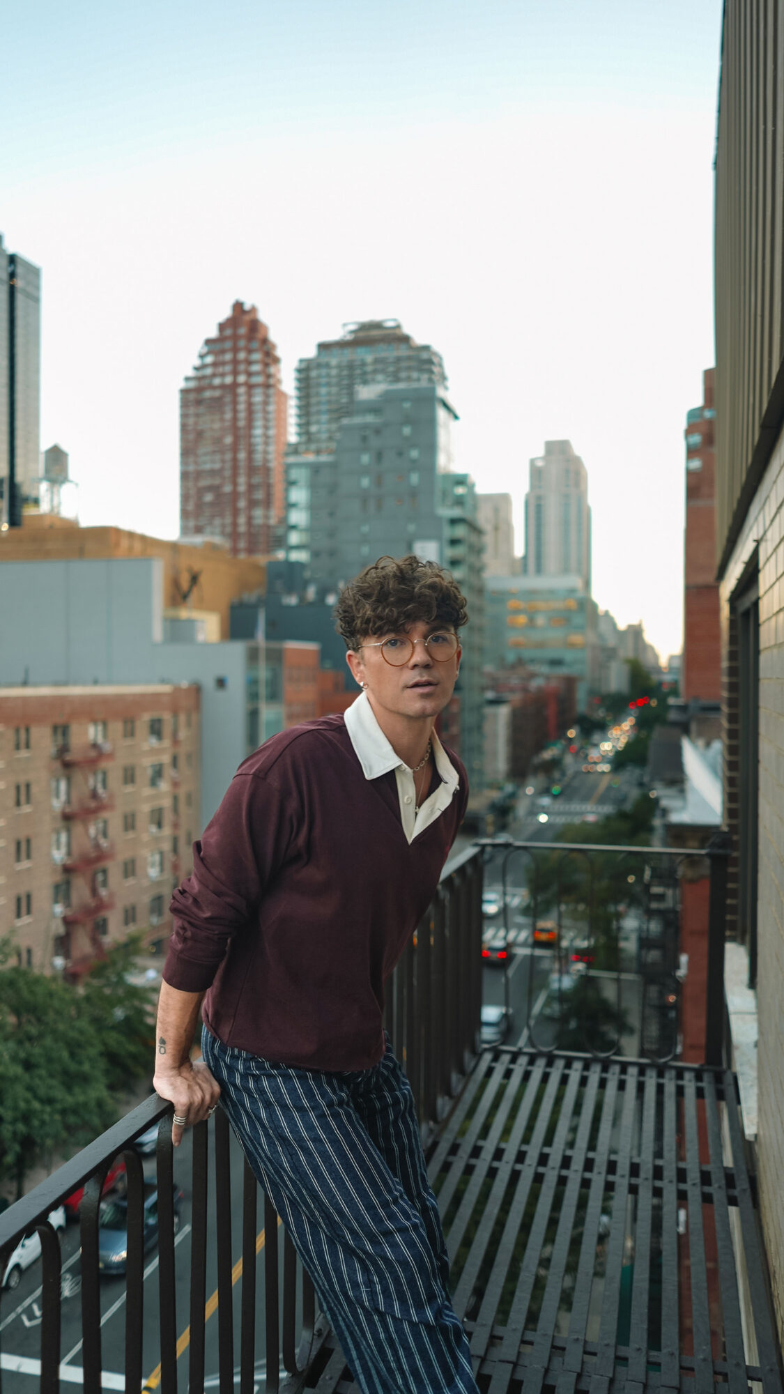 Scout Sixteen / Justin Livingston (justinliv) NYC Men's Fashion Inspiration - Maroon Men's Rugby Shirt Tommy Hilfiger, Men's Striped Blue Jeans Pants, Men's White Leather Sneakers Thursday Boots, New York City Skyline