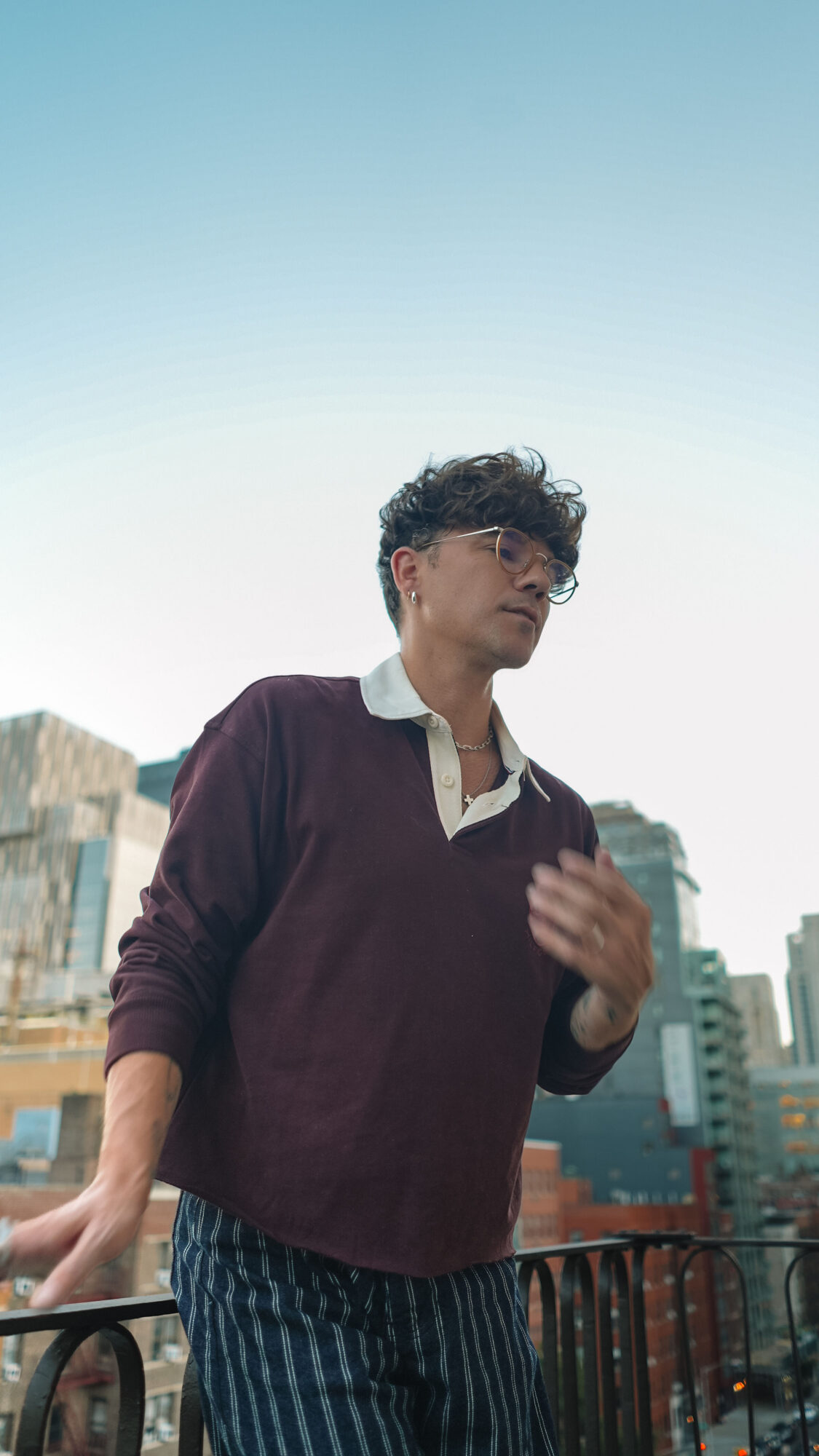 Scout Sixteen / Justin Livingston (justinliv) NYC Men's Fashion Inspiration - Maroon Men's Rugby Shirt Tommy Hilfiger, Men's Striped Blue Jeans Pants, Men's White Leather Sneakers Thursday Boots, New York City Skyline